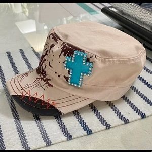 HAT WITH TURQUOISE CROSS ON IT
